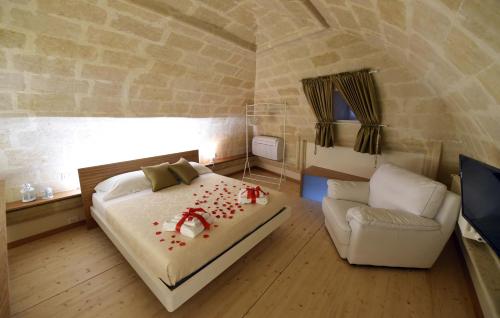 a bedroom with a bed and a couch and a window at Antica Dimora Storica La Finestra Sul Campanile in Matera