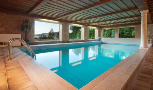 una piscina en una casa con techo en Seehotel Garni Pöllmann en Mondsee