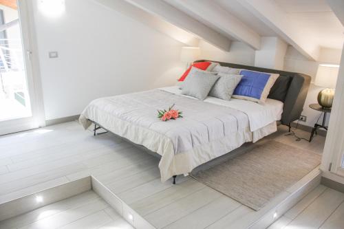 a bedroom with a large bed with colorful pillows at Sky Fort Garda View in Sirmione