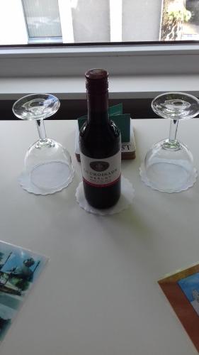 a bottle of wine and two glasses on a table at Het Harlekijntje in Maastricht