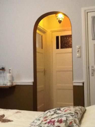 a mirror in a room with a door and a bed at Het Harlekijntje in Maastricht