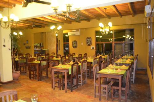 a restaurant with tables and chairs with people sitting at them at Terrazas de Colón in Colón