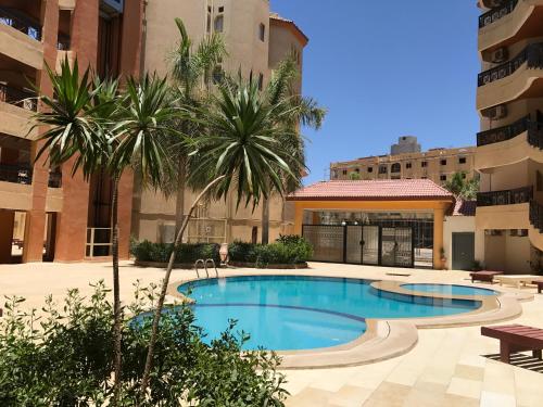a swimming pool in the middle of a building at Regency Towers Apartments in Hurghada