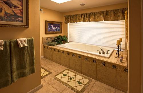 a large bathroom with a tub and a window at Rocky Point Ranch in Eddy