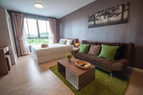 a living room with a couch and a bed at Baan Peang Ploen Huahin by Alice in Hua Hin