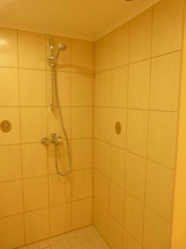 a shower with a shower head in a bathroom at Viva Pirita Hostel in Tallinn