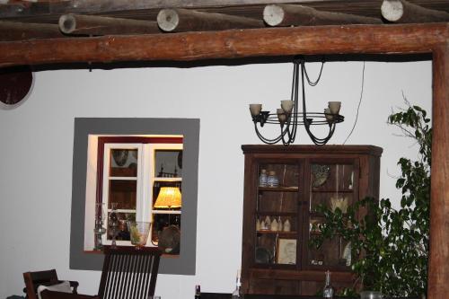 a dining room with a mirror and a chandelier at Monte Da Morena Agro-Turismo in Serpa