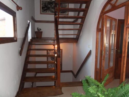 a wooden spiral staircase in a room with a door at Antsirabe Hotel in Antsirabe