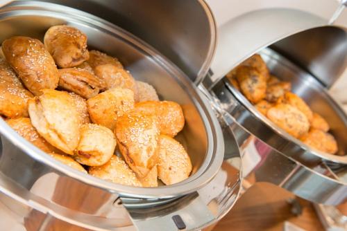 a pot full of sesameinated bagels sitting on a stove at Angelica Hotel in Limenas