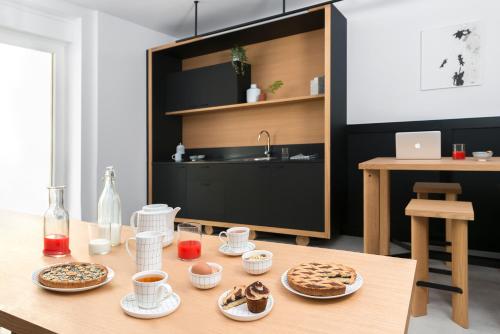a table with plates of food on top of it at BnBiz - Coworking Hotel in Fiorenzuola dʼArda