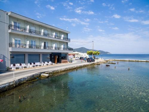 a hotel on the shore of a body of water at Angelica Hotel in Limenas