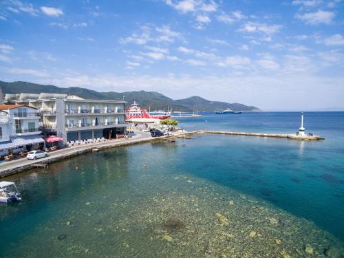 a large body of water with buildings and a pier at Angelica Hotel in Limenas