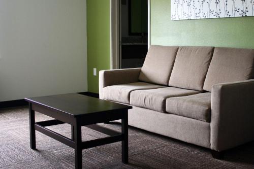 a living room with a couch and a table at Sleep Inn & Suites Galion in Galion