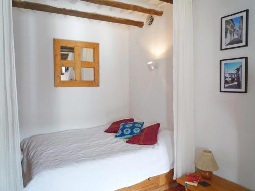 a bedroom with a white bed and a window at Casita Buena Vista in Bubión