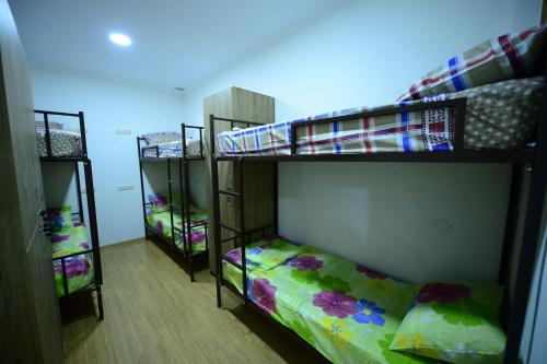 a room with three bunk beds in a room at Hostel 17 Only for men in Tbilisi City