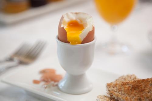 an egg in a egg carton on a table at Serendipity Country House & Restaurant in Wilderness