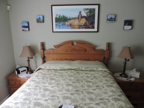 a bedroom with a bed and a picture on the wall at Tucked Inn the Harbour B&B in Victoria Harbour