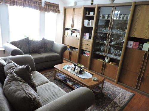 a living room with a couch and a coffee table at Tucked Inn the Harbour B&B in Victoria Harbour