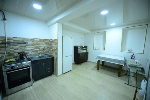 a kitchen with a stove and a sink and a table at Hostel 17 Only for men in Tbilisi City