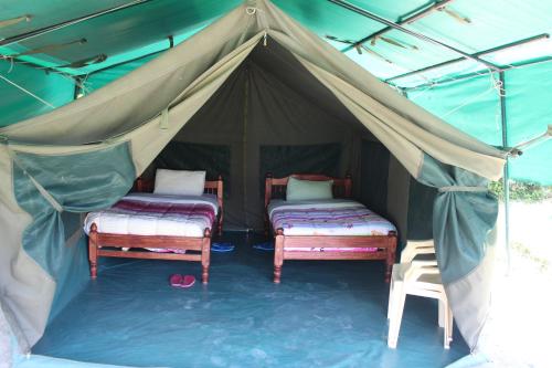 a tent with two beds in the middle of it at Cactus Eco Camp and Lodge in Elmenteita