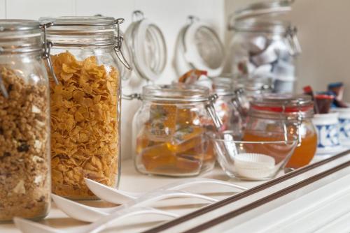 a counter with many jars of nuts and jams at Hotel Restaurant Mondriaan in Winterswijk