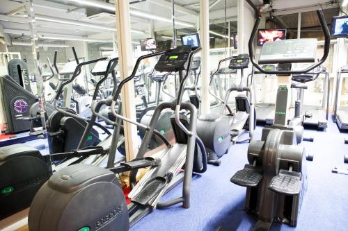 a gym with several rows of treadmills and cardio machines at Hotel Westport - Leisure Spa and Conference in Westport