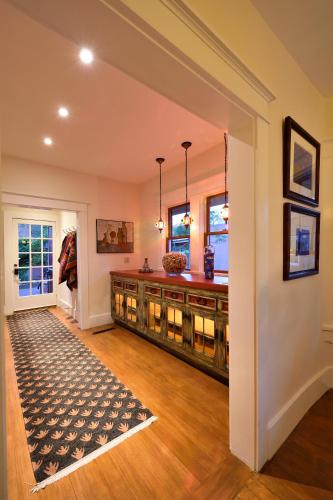 a home entry with a largeoyer with a table and a rug at Casa Culinaria - The Gourmet Inn in Santa Fe
