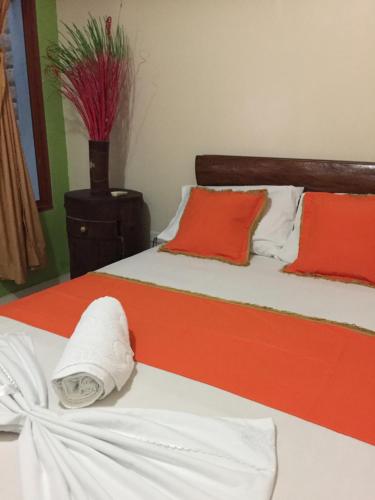 a bedroom with two beds with red and white sheets at ApartaHotel Tierras Amazonicas in Leticia