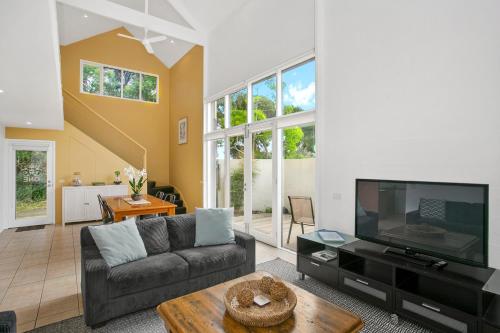 a living room with a couch and a tv at Terrace Lofts Apartments in Ocean Grove