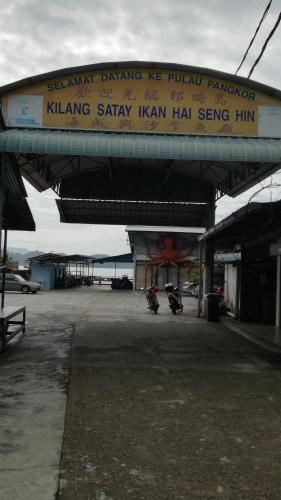a gas station with a sign on the top of it at Pangkor Home Sea Village in Pangkor