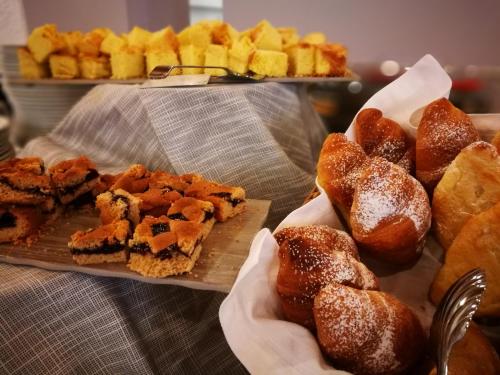 a bunch of different types of pastries on a table at Style Hotel Grifone in Madonna di Campiglio