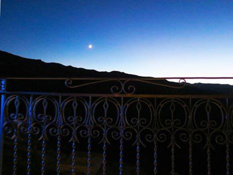 an iron fence with the moon in the sky at Porta Baciamano in Geraci Siculo