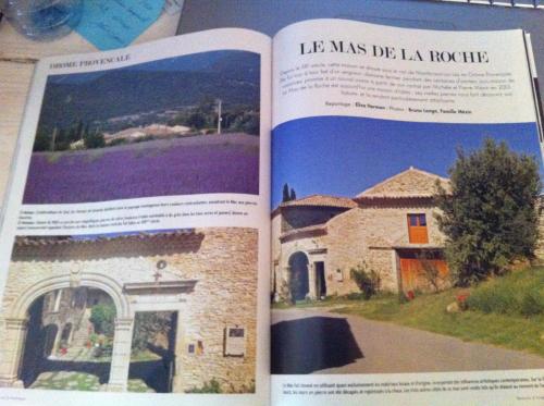 a book with a picture of a house at Le Mas de la Roche in Montbrison-sur-Lez