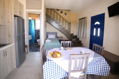 a kitchen with a table with a bowl of fruit on it at Blue SeaSide Studios in Fanari