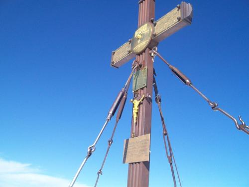 a wooden cross with a clock on top of it at Ferienwohnung Prast in Ainet