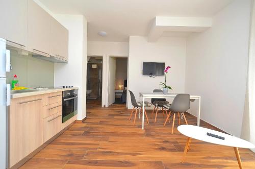 a kitchen and dining room with a table and chairs at Stella Apartments in Novigrad Istria