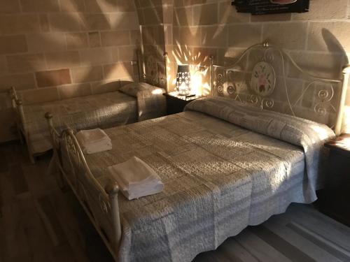 a bedroom with a bed and a couch at Li Caseddi ti lu Cesarinu in Avetrana