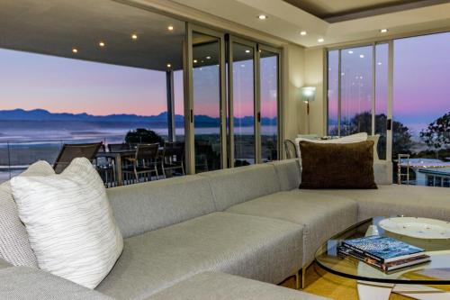a living room with a couch and a table at No1 Sangaree in Plettenberg Bay