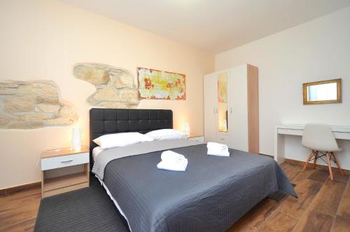a bedroom with a bed with two towels on it at Stella Apartments in Novigrad Istria