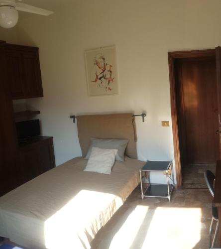 a bedroom with a bed and a small table at B&B Jacopino in Florence