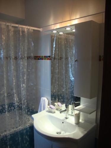 a bathroom with a sink and a shower at Volissos Homes in Volissos
