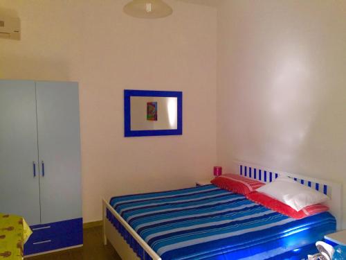 トッレ・ラピッロにあるVillino rossoの小さなベッドルーム(青と白のベッド付)
