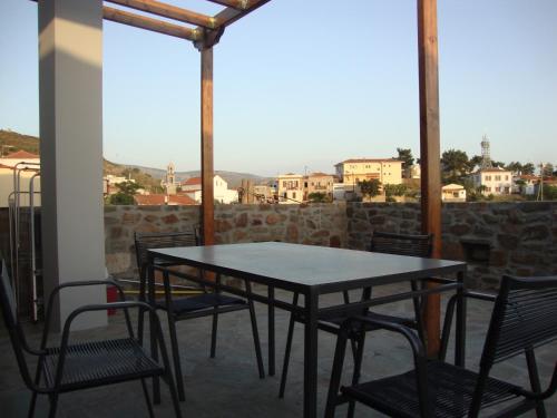 a table and chairs on a balcony with a view at Volissos Homes in Volissos