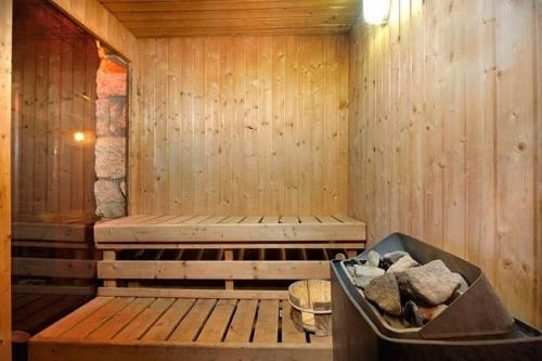 a wooden sauna with a tub of rocks in it at Villa Joe in Peqi‘in H̱adasha