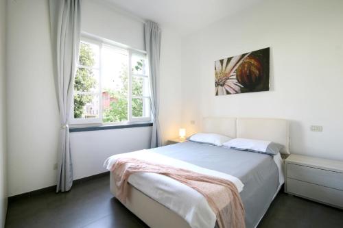 A bed or beds in a room at Bonnes Vacances a Pietrasanta