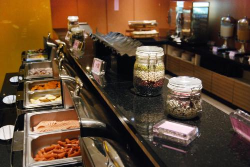 a buffet line in a restaurant with ingrediantspectspectssenalsenalsenalsenalsenal at Century Hotel Taoyuan in Taoyuan