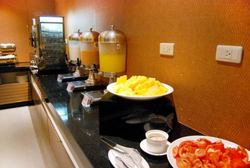 a kitchen with two bowls of fruit on a counter at Century Hotel Taoyuan in Taoyuan