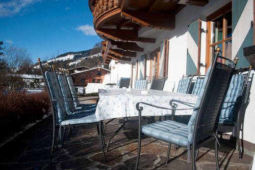 a table and chairs sitting on a patio at Pension Sonnhof in Brixen im Thale