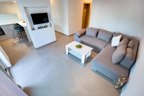 a living room with a couch and a table at Croatica Suites Brodarica in Brodarica