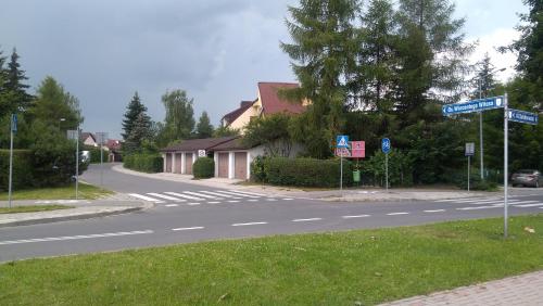 an empty street with street signs on the side of the road at Apartament U Janusza in Nowy Targ